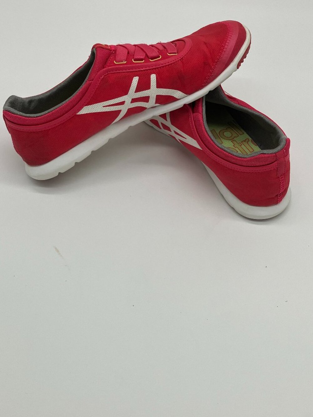 The Asics Q459Y Women's Pink Low Top Slip-On Sneakers in size 9